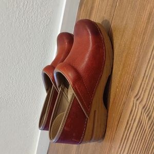 Unique Dansko waxy burnish clogs. Beautiful red with natural variation.